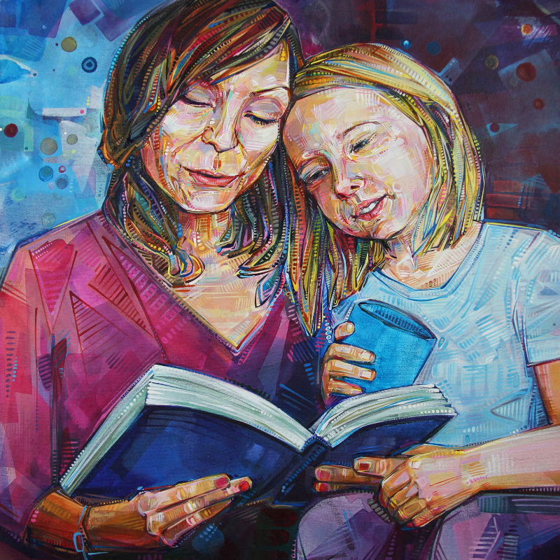 portrait of a white mother and daughter, the girl sitting in her mother’s lap as they read together