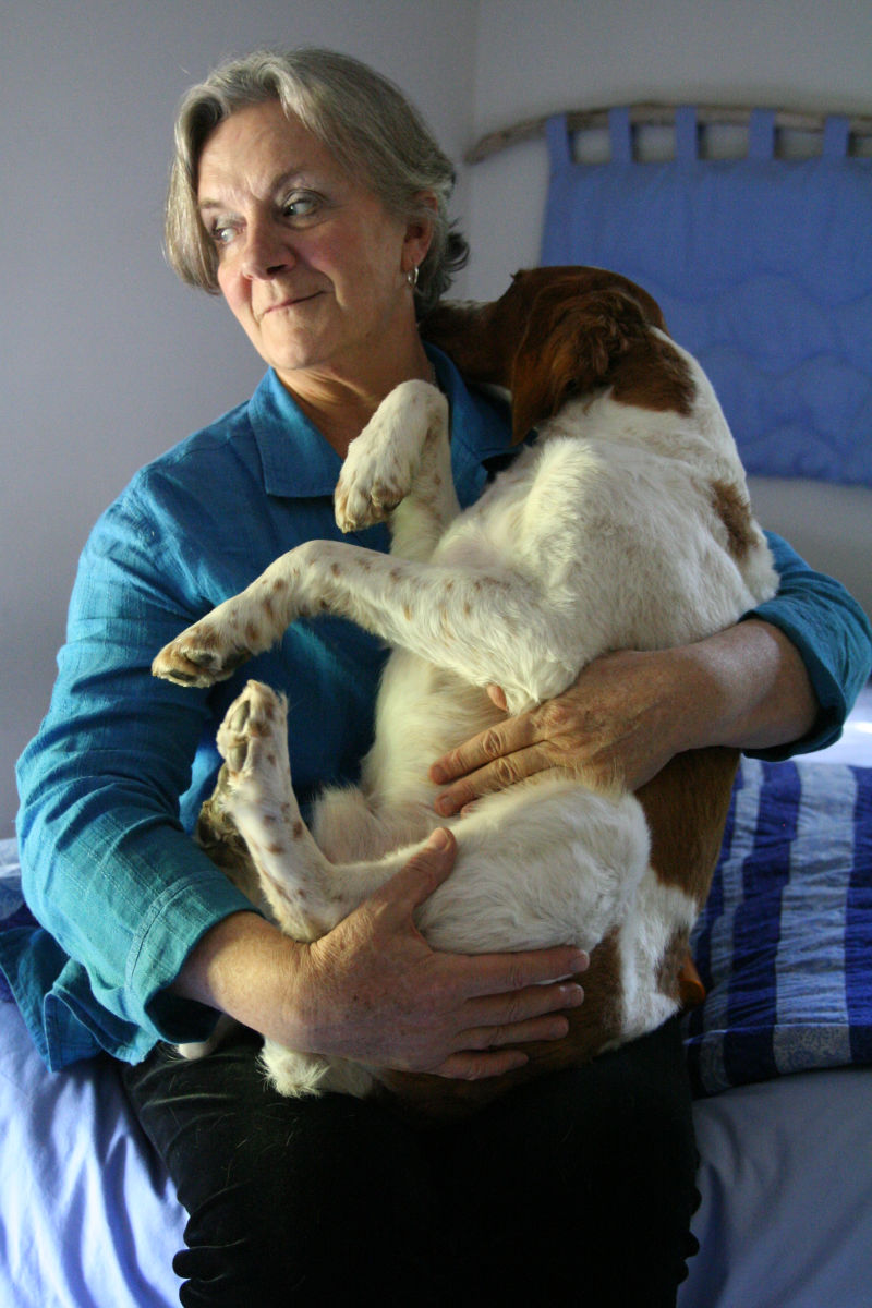 dog cradled in a woman’s arms