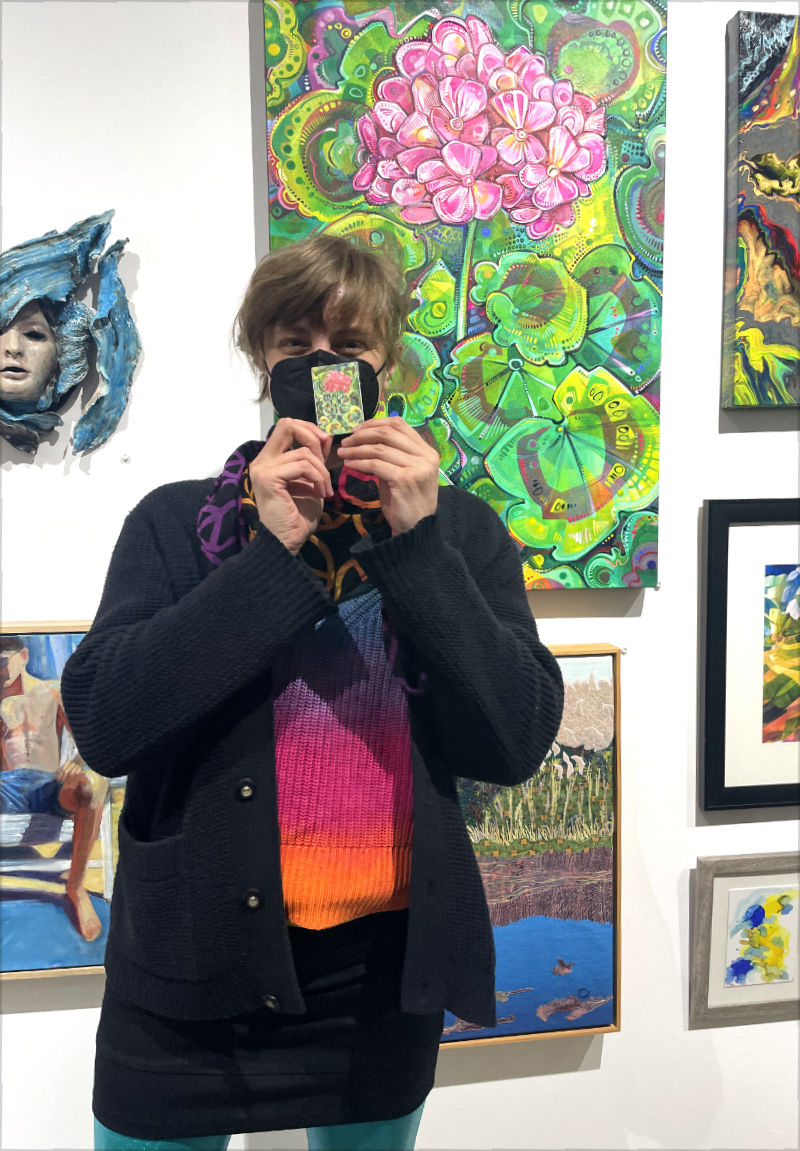 Gwenn Seemel with their geranium painting at Monmouth Museum