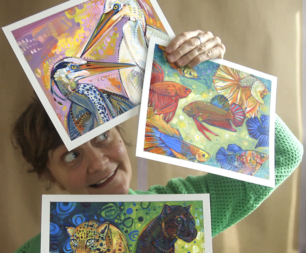 artist Gwenn Seemel holding some studies for animal paintings